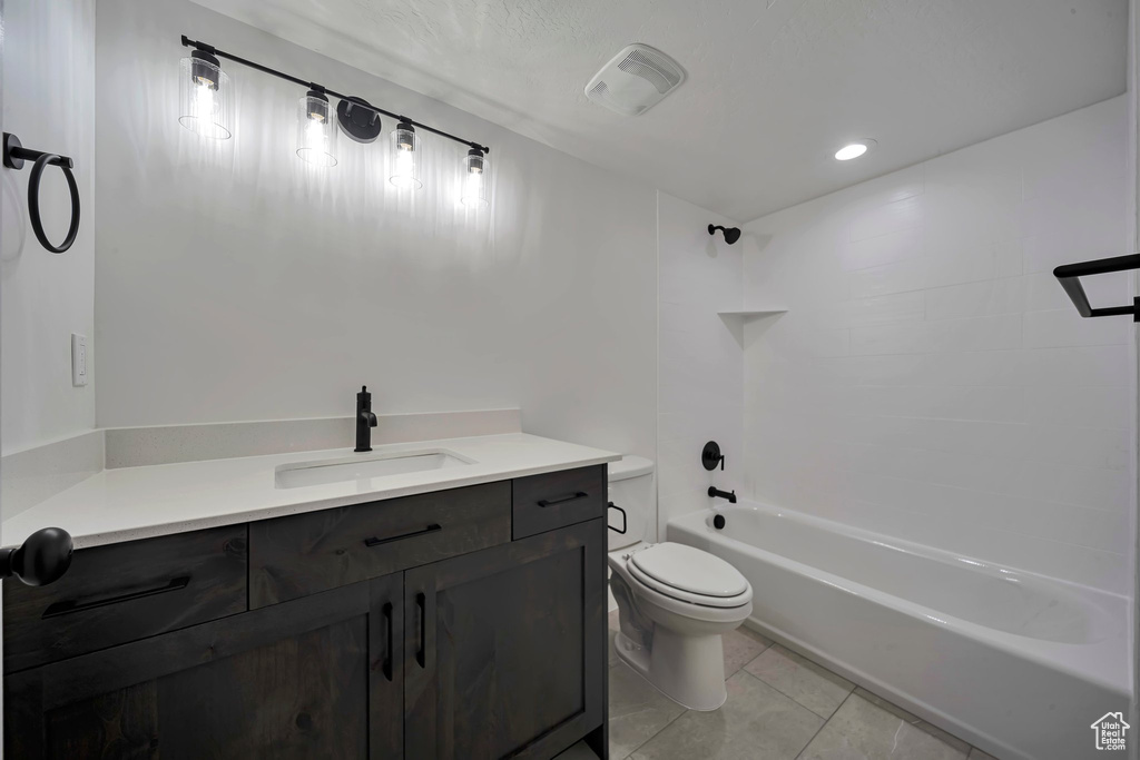 Full bathroom featuring vanity, toilet, tub / shower combination, and tile patterned floors