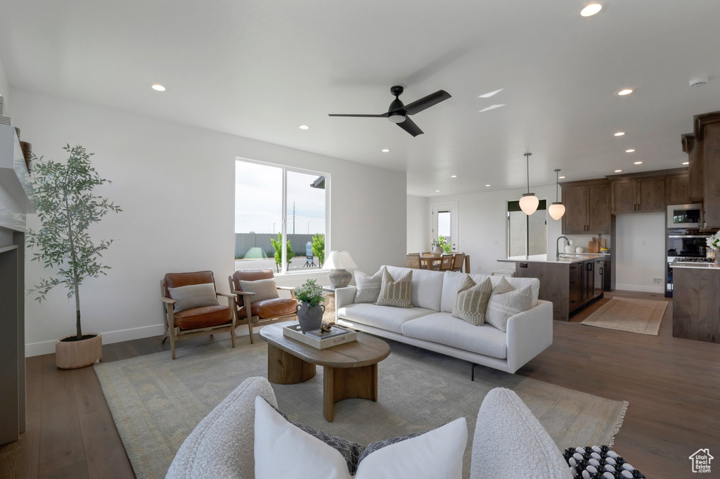 Living room with recessed lighting, light wood-type flooring, and ceiling fan