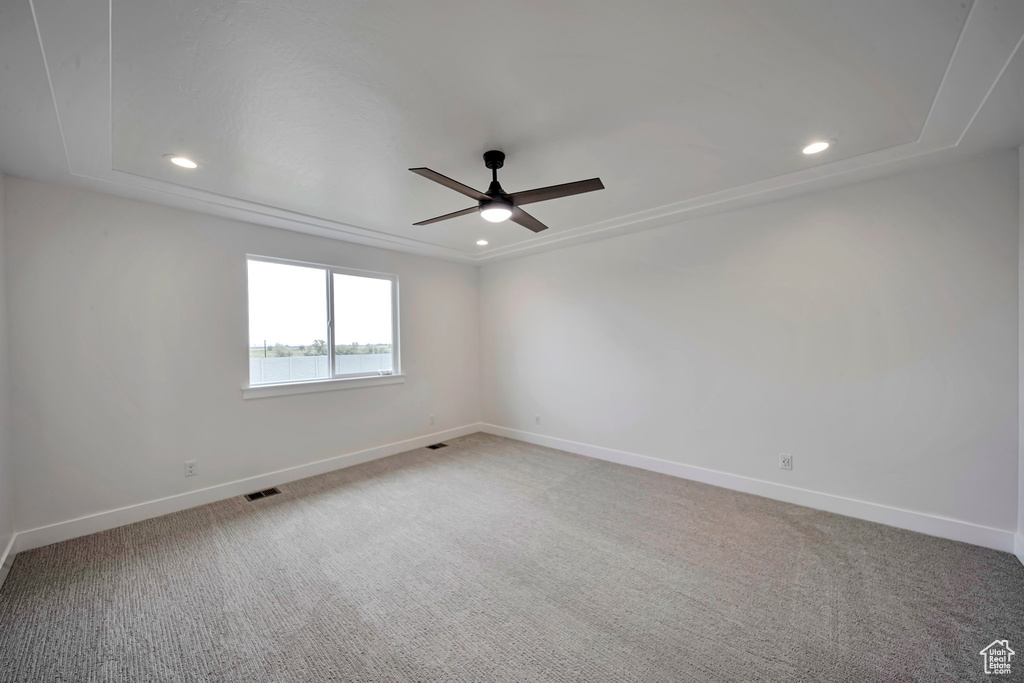 Empty room featuring a ceiling fan, baseboards, light carpet, and recessed lighting