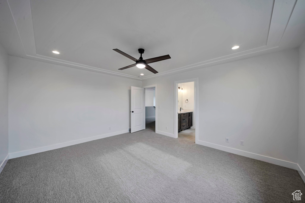 Unfurnished bedroom featuring baseboards, recessed lighting, light carpet, connected bathroom, and a ceiling fan