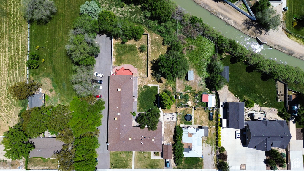 Aerial view of property and surrounding area featuring a nearby body of water