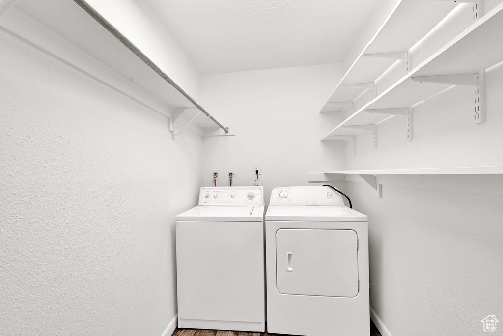 Washroom featuring washer and clothes dryer and baseboards