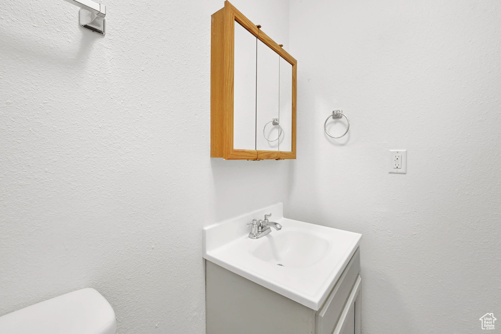 Half bath with vanity and toilet