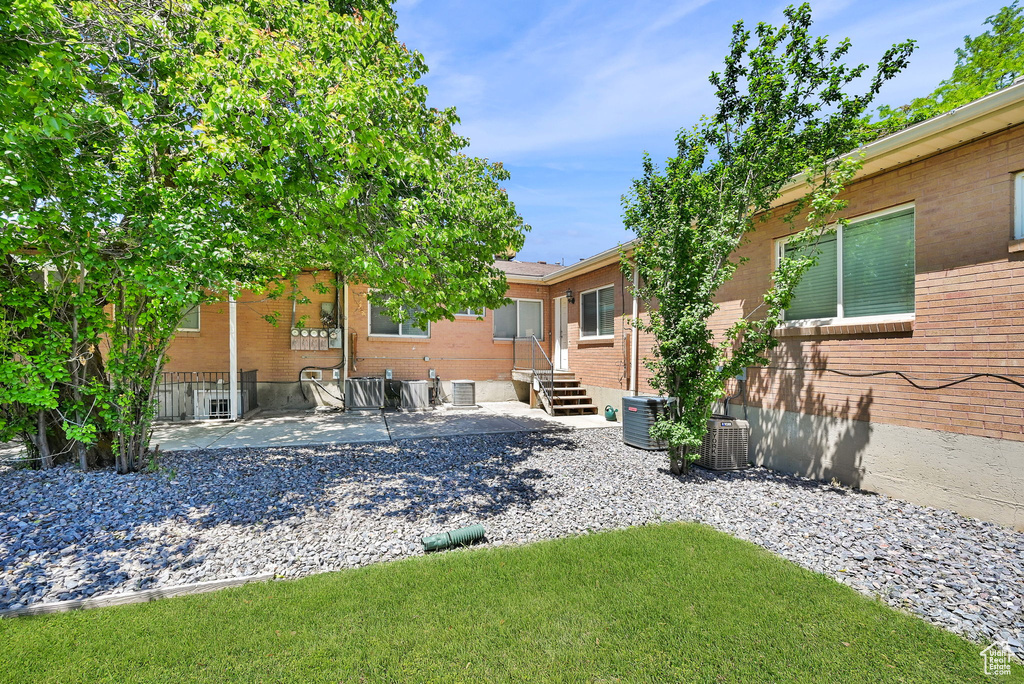 View of yard with a patio and cooling unit