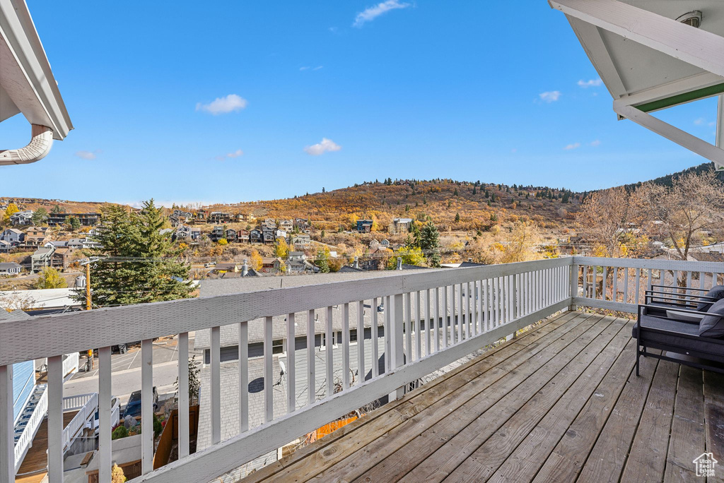 Wooden terrace featuring a mountain view and a residential view