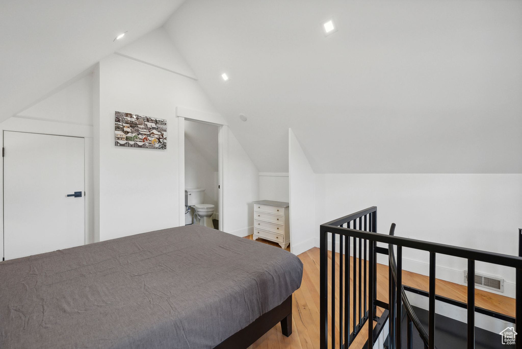 Bedroom featuring vaulted ceiling, light wood-type flooring, and recessed lighting