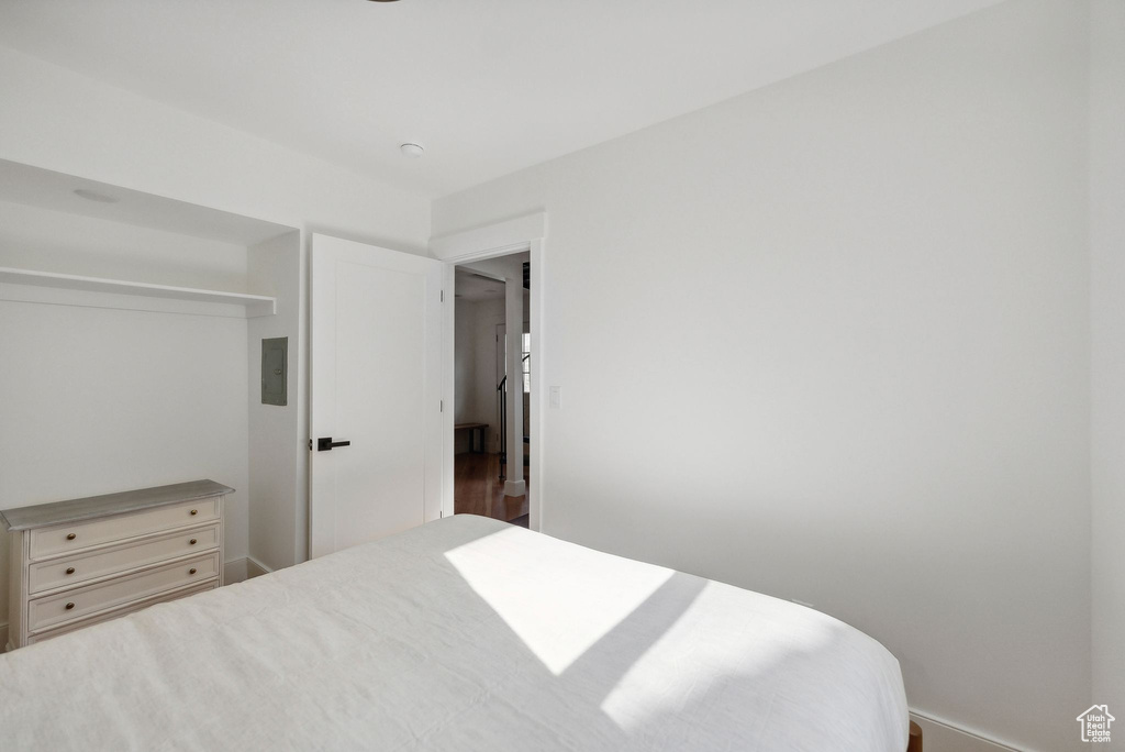 Bedroom with baseboards and wood finished floors