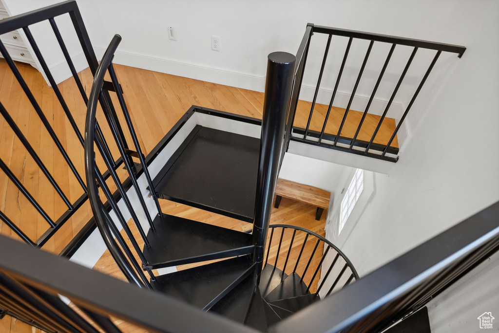 Stairs with baseboards and wood finished floors