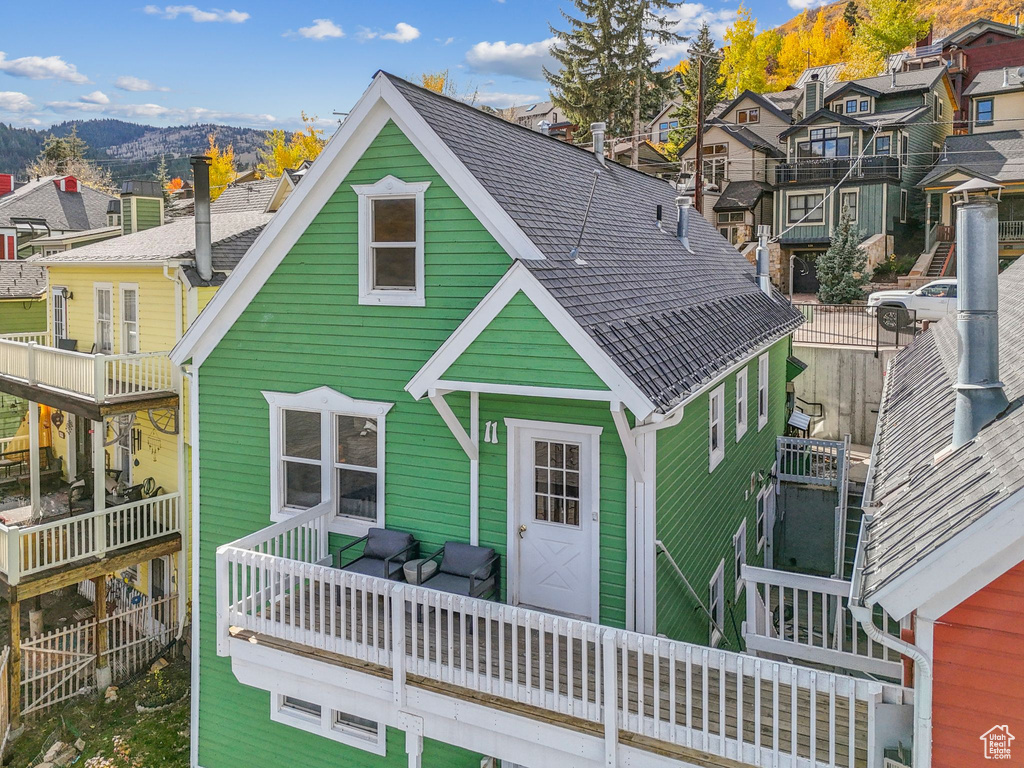 Back of house featuring a mountain view and a residential view