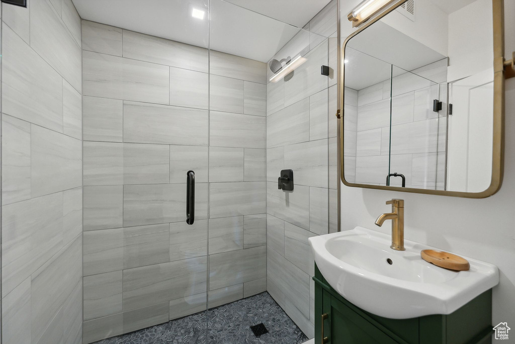 Bathroom featuring vanity and a stall shower