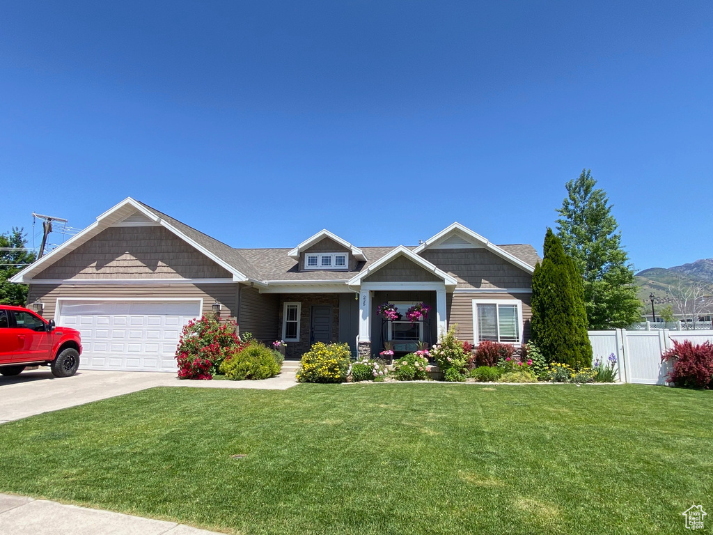 Craftsman inspired home featuring a garage and concrete driveway