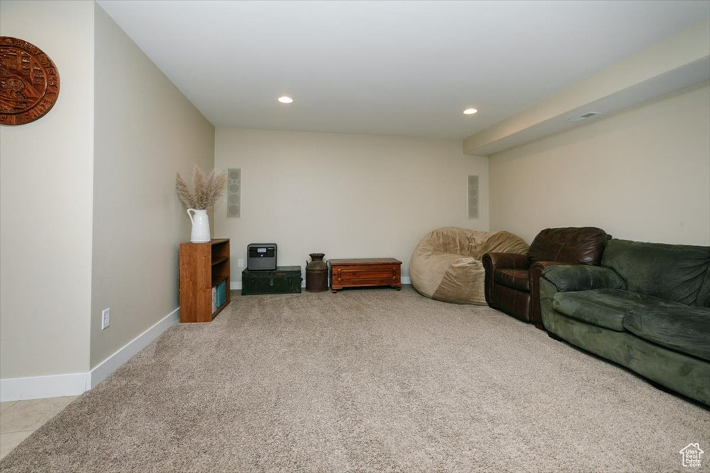 Living room with light carpet, recessed lighting, and baseboards