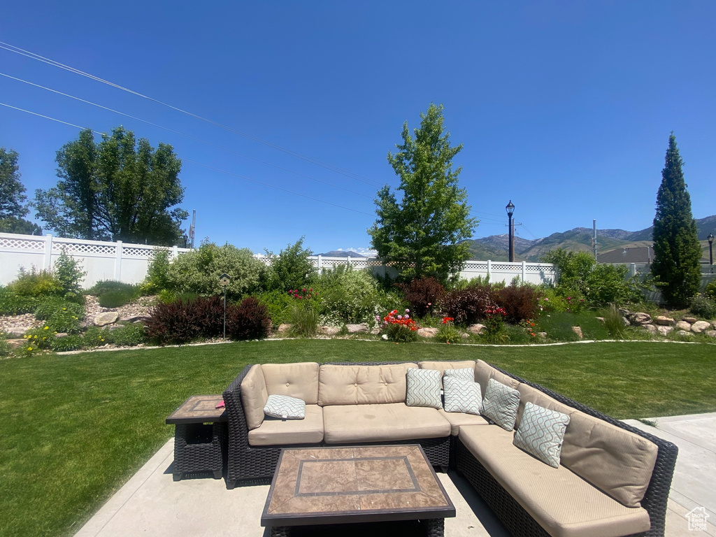 View of patio / terrace featuring an outdoor hangout area and a mountain view