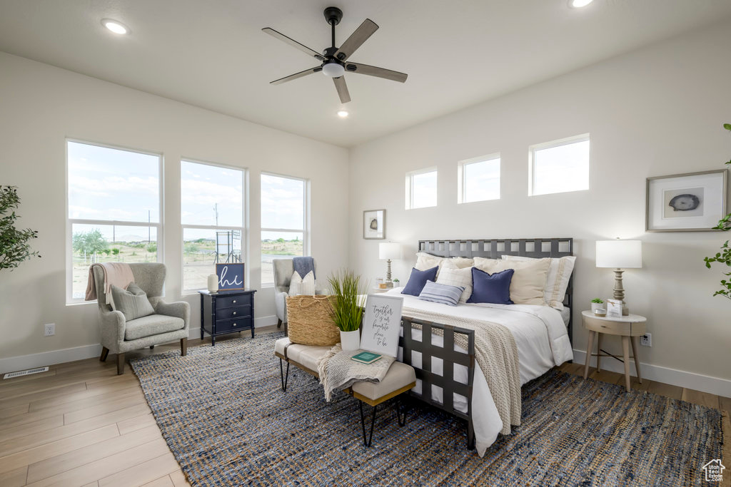 Bedroom with baseboards, recessed lighting, wood finished floors, and ceiling fan