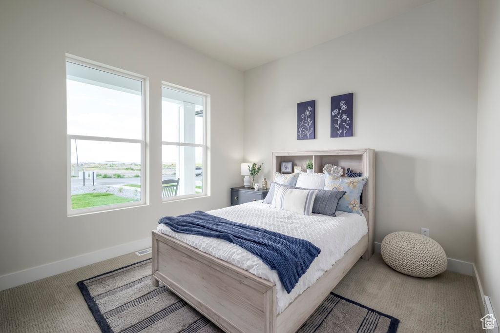 Bedroom featuring carpet flooring and baseboards