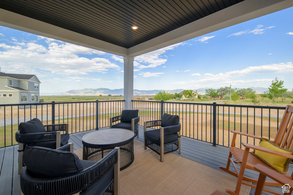 Wooden deck with a mountain view and an outdoor hangout area