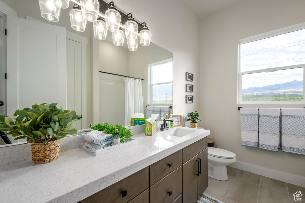 Full bath with vanity, tile patterned flooring, toilet, a shower with shower curtain, and a chandelier