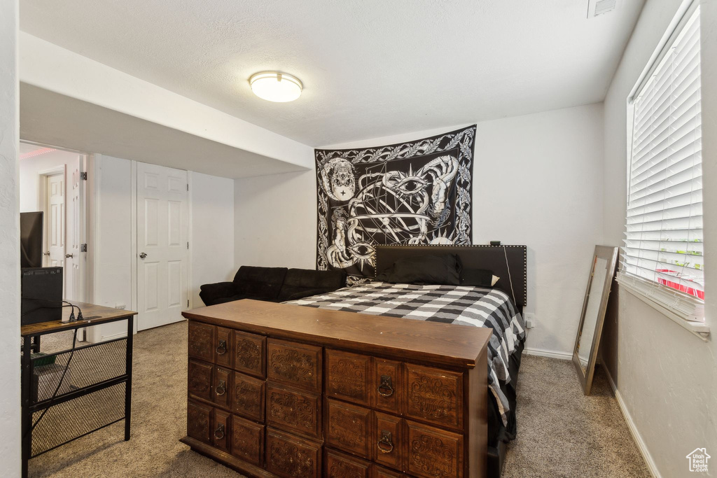 Bedroom featuring carpet flooring and baseboards