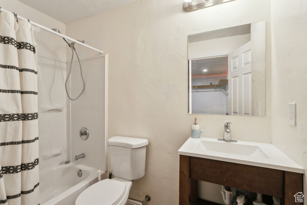 Bathroom featuring toilet and shower / tub combo