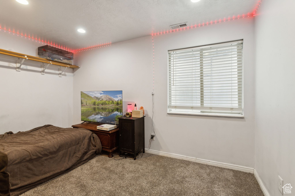 Carpeted bedroom with recessed lighting and baseboards