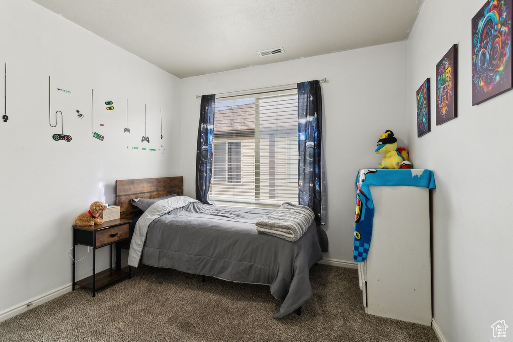 Carpeted bedroom with baseboards