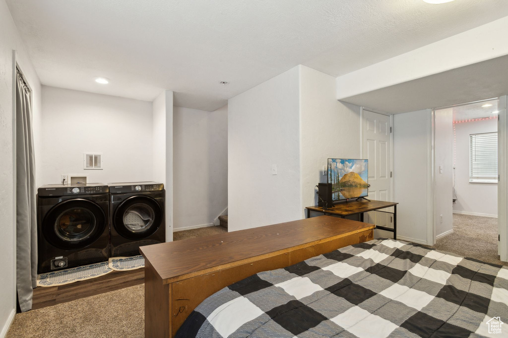 Bedroom with washing machine and clothes dryer, carpet floors, baseboards, and recessed lighting