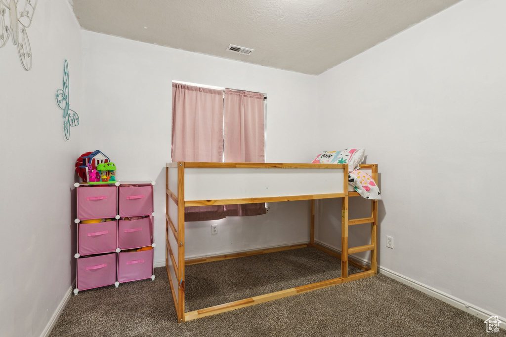 Bedroom with carpet and baseboards