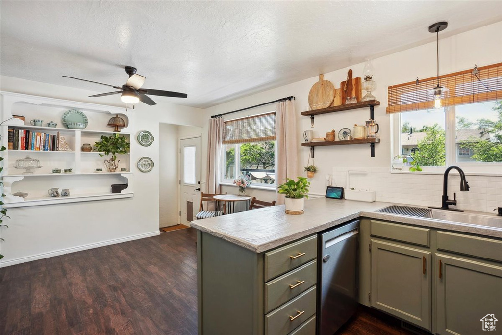 Kitchen with dishwasher, gray cabinets, a sink, a peninsula, and light countertops