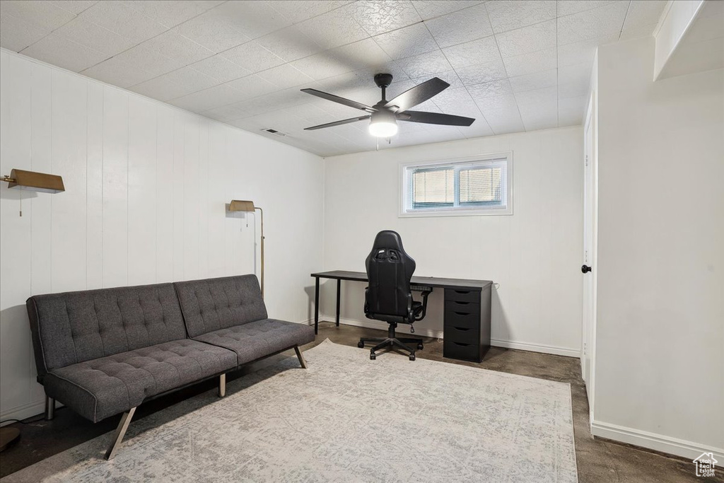 Office space with a ceiling fan and baseboards
