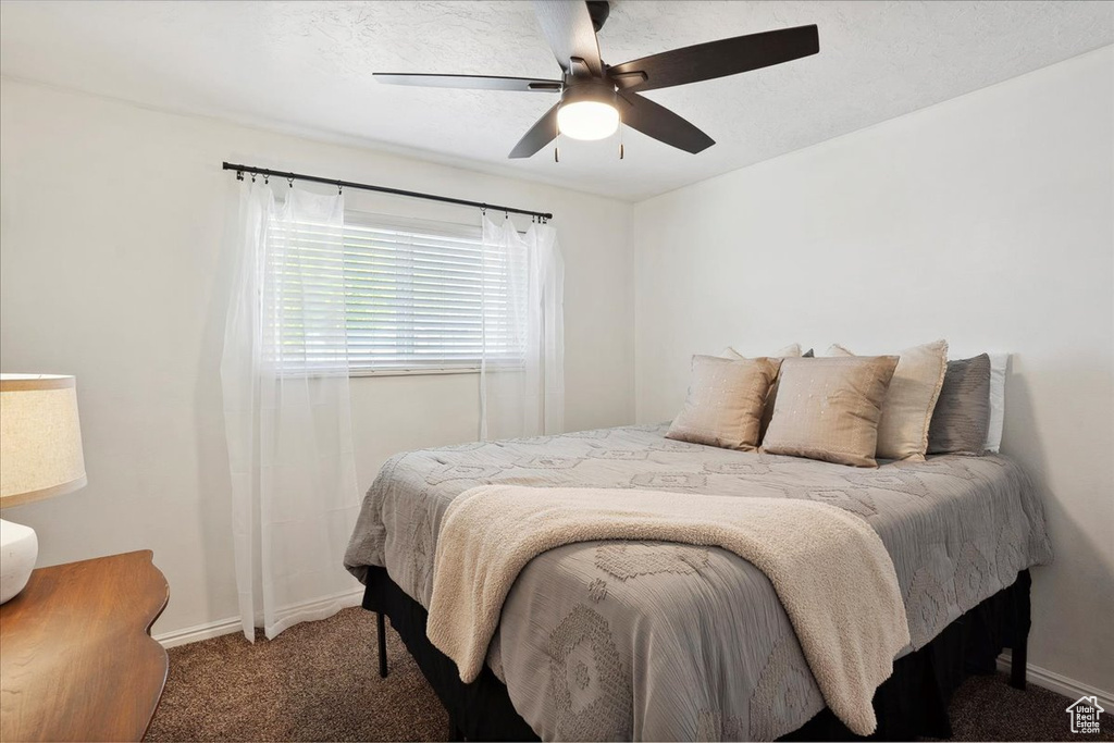 Bedroom featuring carpet flooring, baseboards, and a ceiling fan