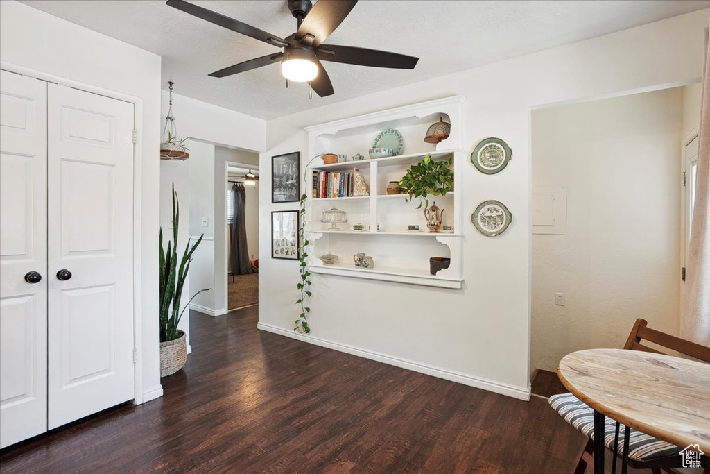 Dining space featuring a ceiling fan, wood finished floors, and baseboards
