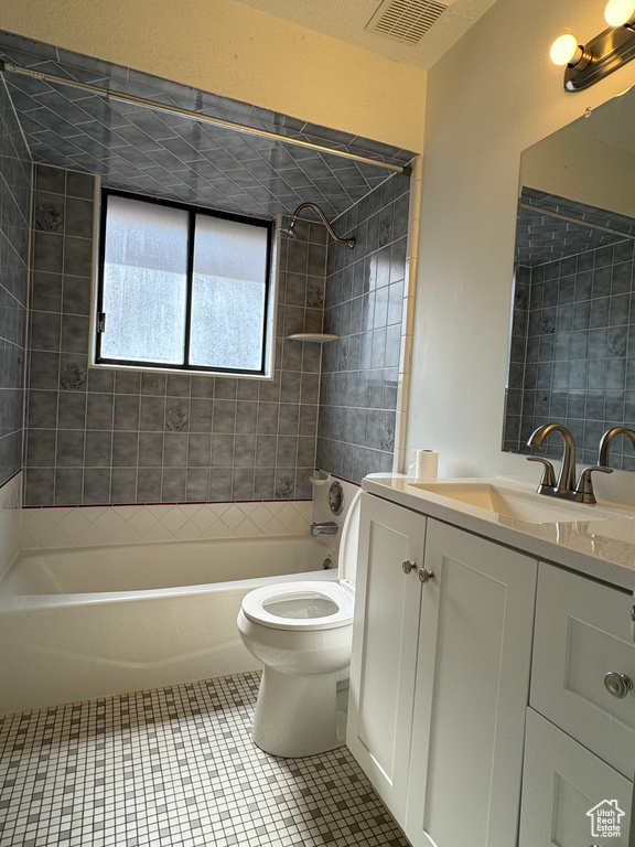 Full bathroom with vanity, toilet, shower / tub combination, and tile patterned flooring