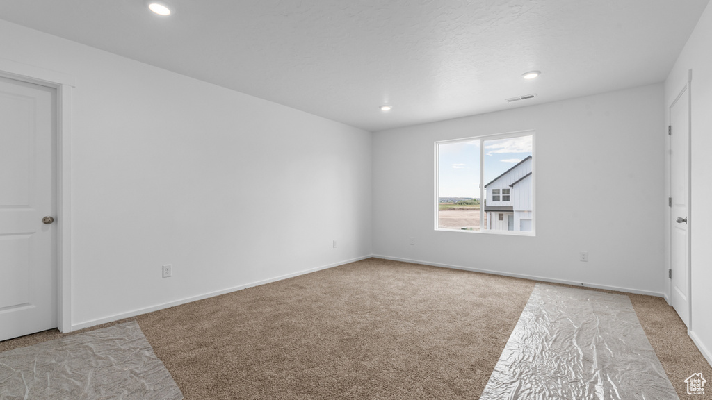Spare room with carpet flooring, recessed lighting, and baseboards