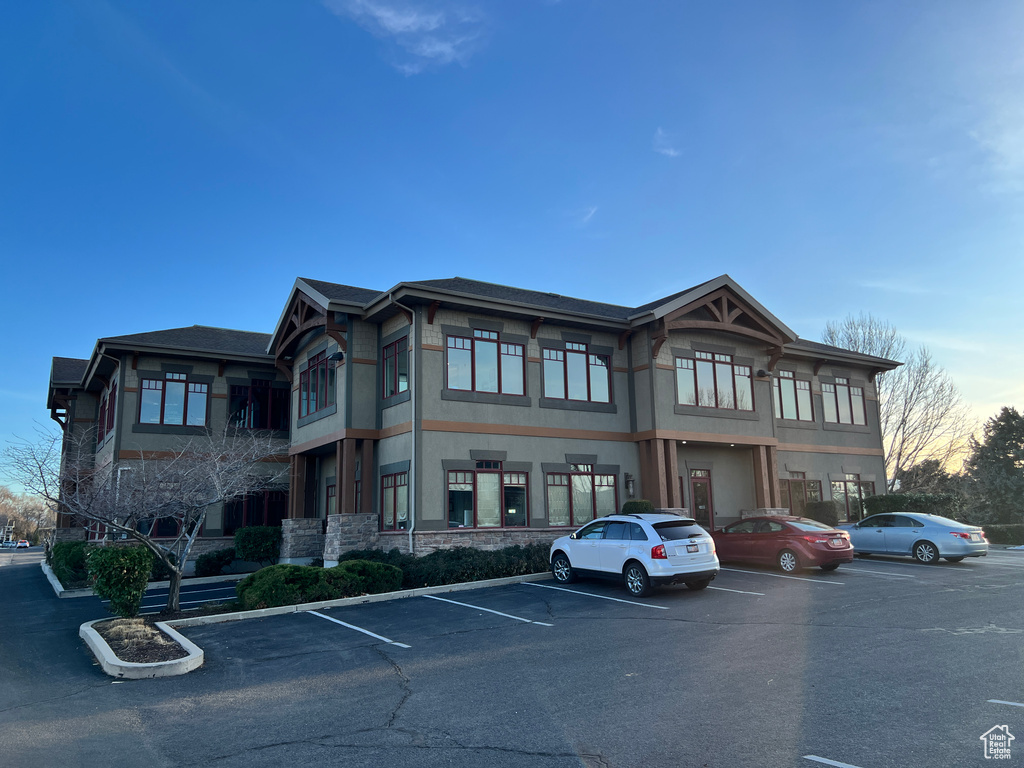 View of building exterior featuring uncovered parking
