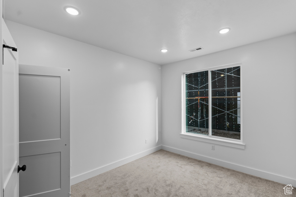Empty room with carpet flooring, baseboards, and recessed lighting