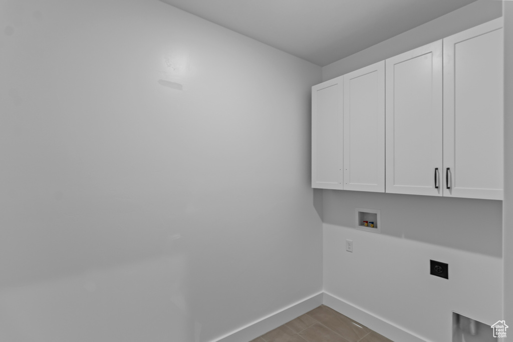 Laundry room featuring cabinet space, hookup for an electric dryer, baseboards, and hookup for a washing machine