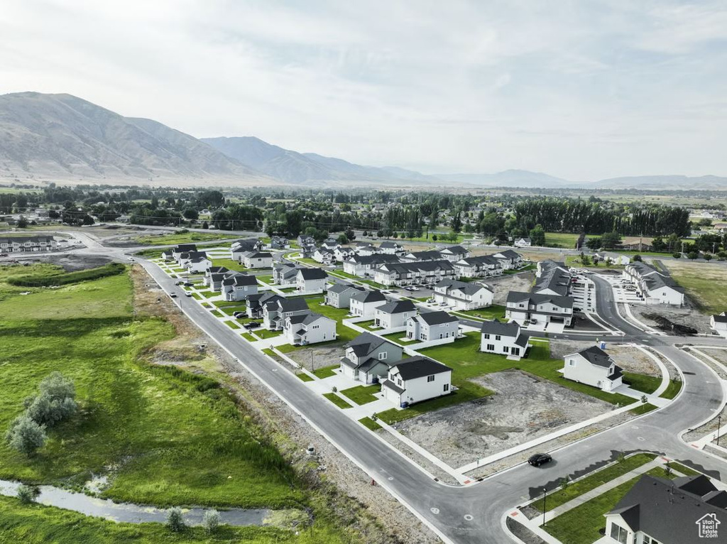 Aerial overview of property's location featuring a mountain backdrop and nearby suburban area