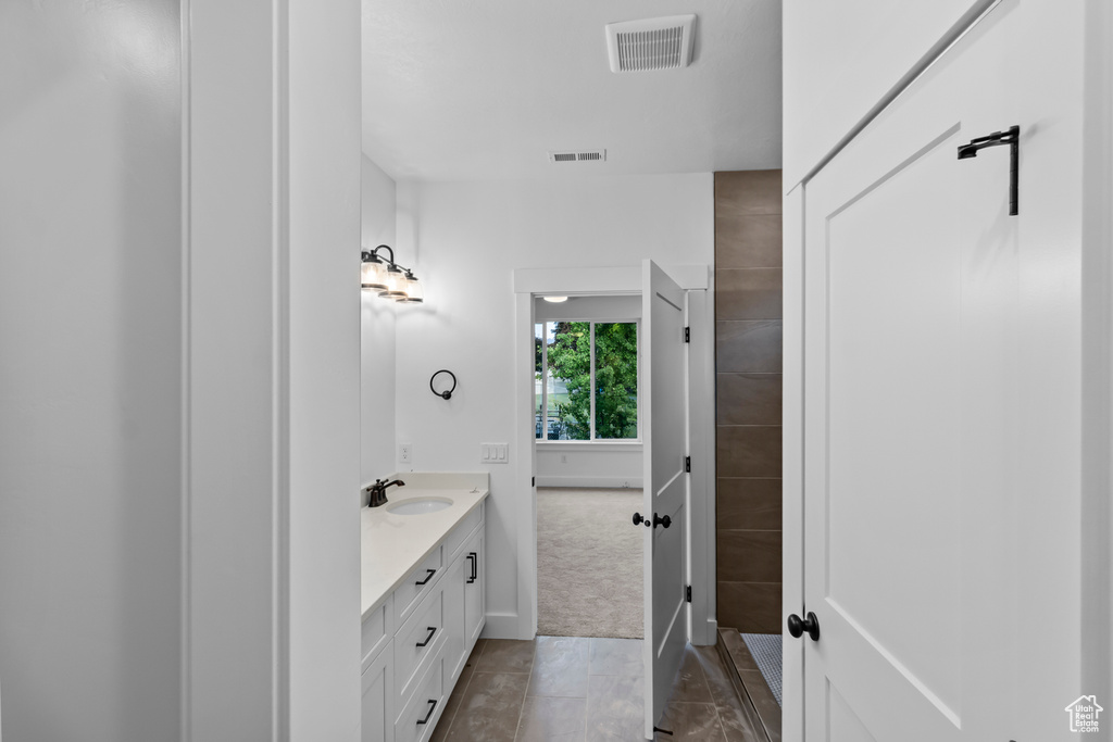 Bathroom with double vanity and baseboards