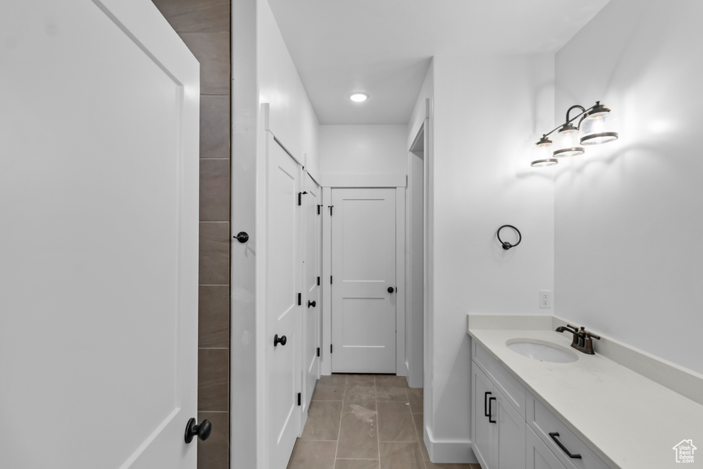 Bathroom with vanity, tile patterned flooring, and recessed lighting