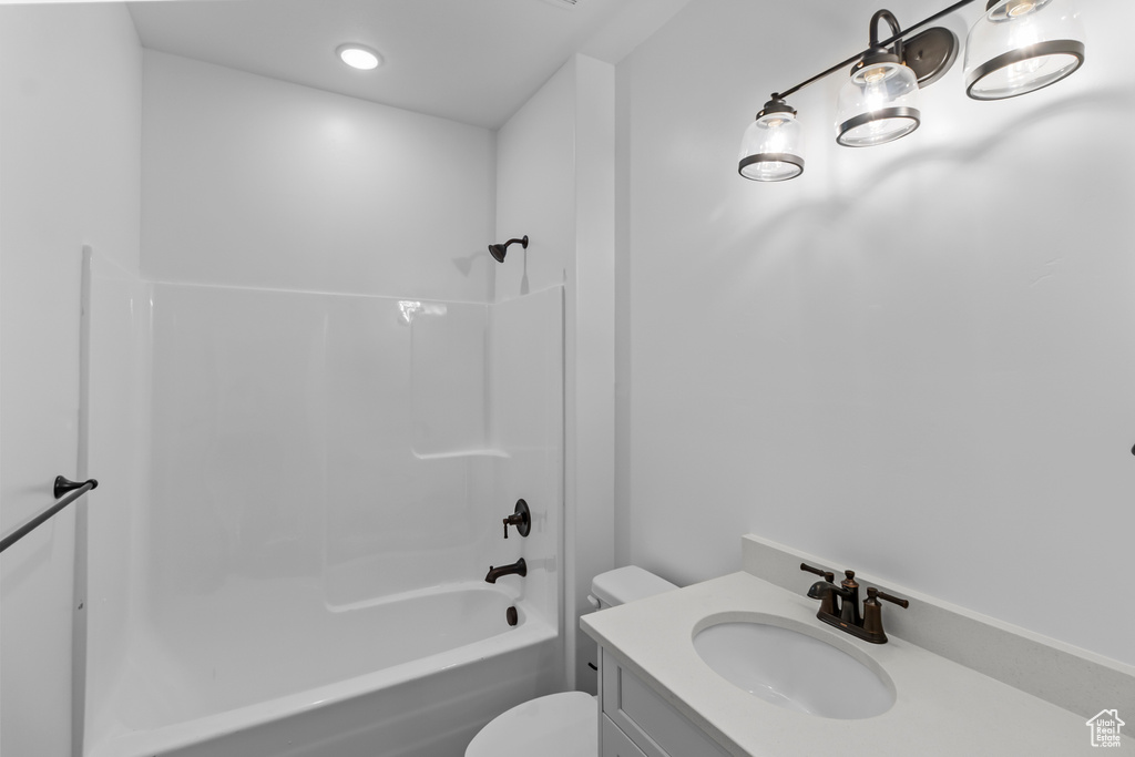 Bathroom with toilet, bathing tub / shower combination, and vanity