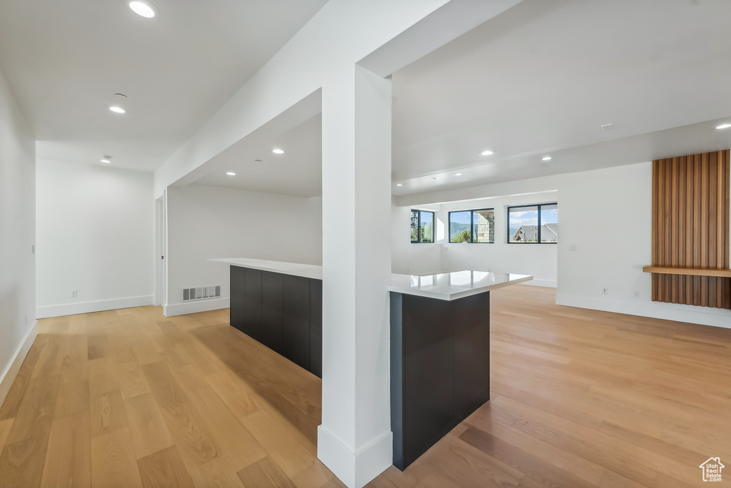 Kitchen with modern cabinets, open floor plan, light wood-style flooring, recessed lighting, and light countertops