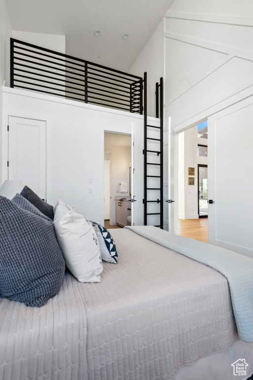 Bedroom with a high ceiling and recessed lighting