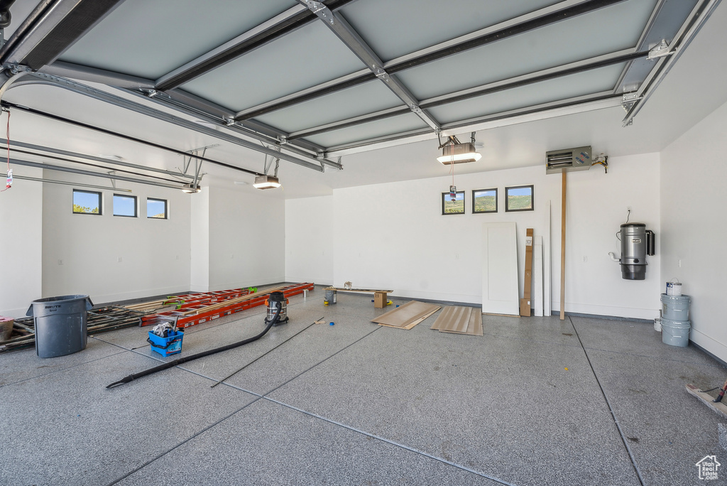 Garage featuring a central vacuum unit and a garage door opener