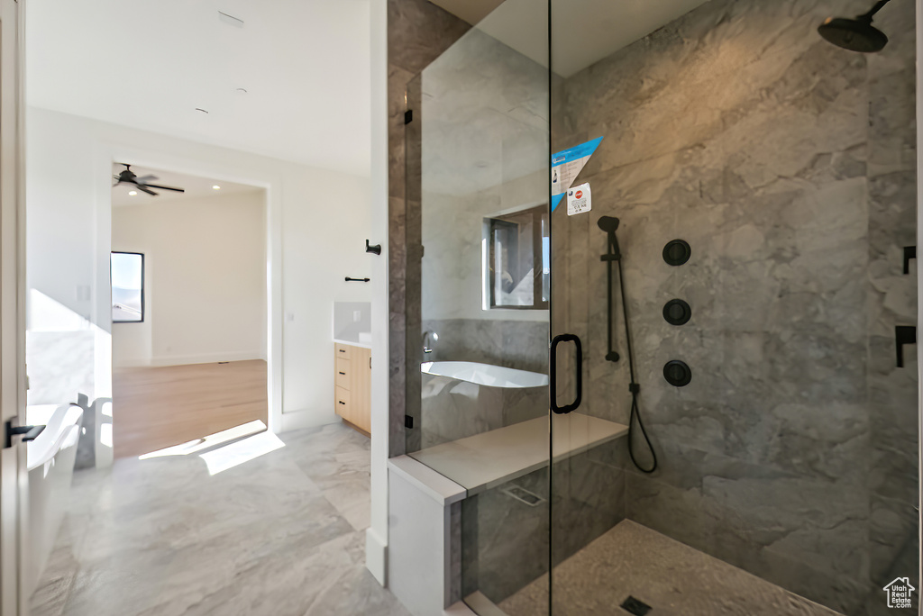 Full bathroom featuring a marble finish shower, a ceiling fan, marble finish floors, and a bathtub