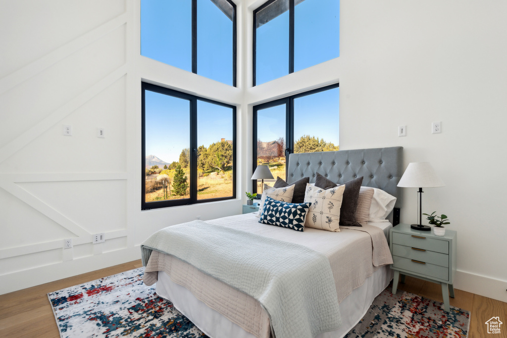Bedroom with multiple windows and wood finished floors