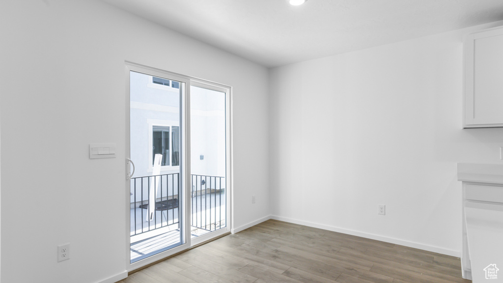 Unfurnished dining area with light wood-style floors, baseboards, and recessed lighting
