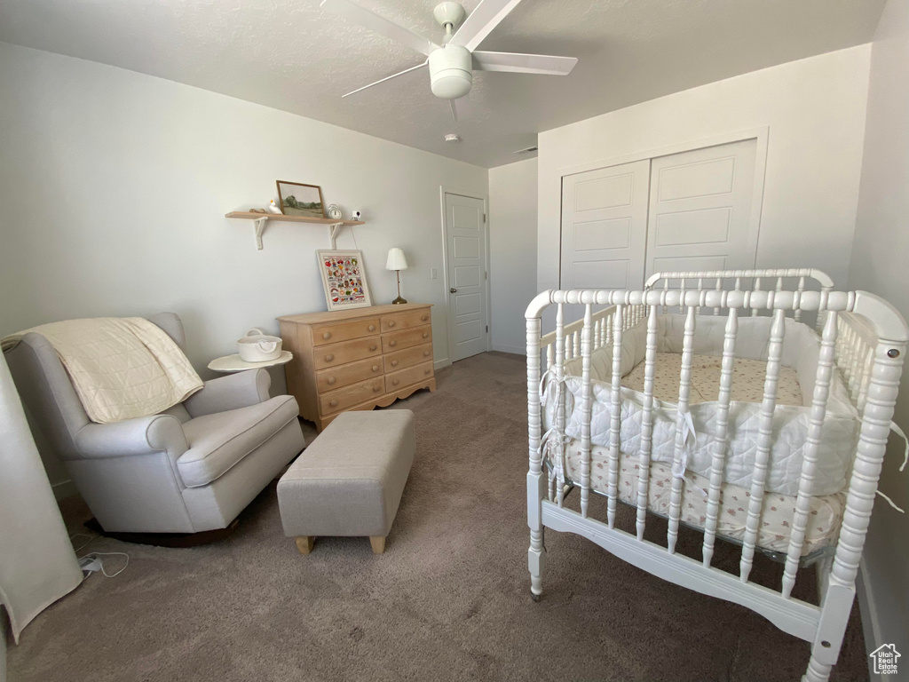 Carpeted bedroom with a closet and a ceiling fan