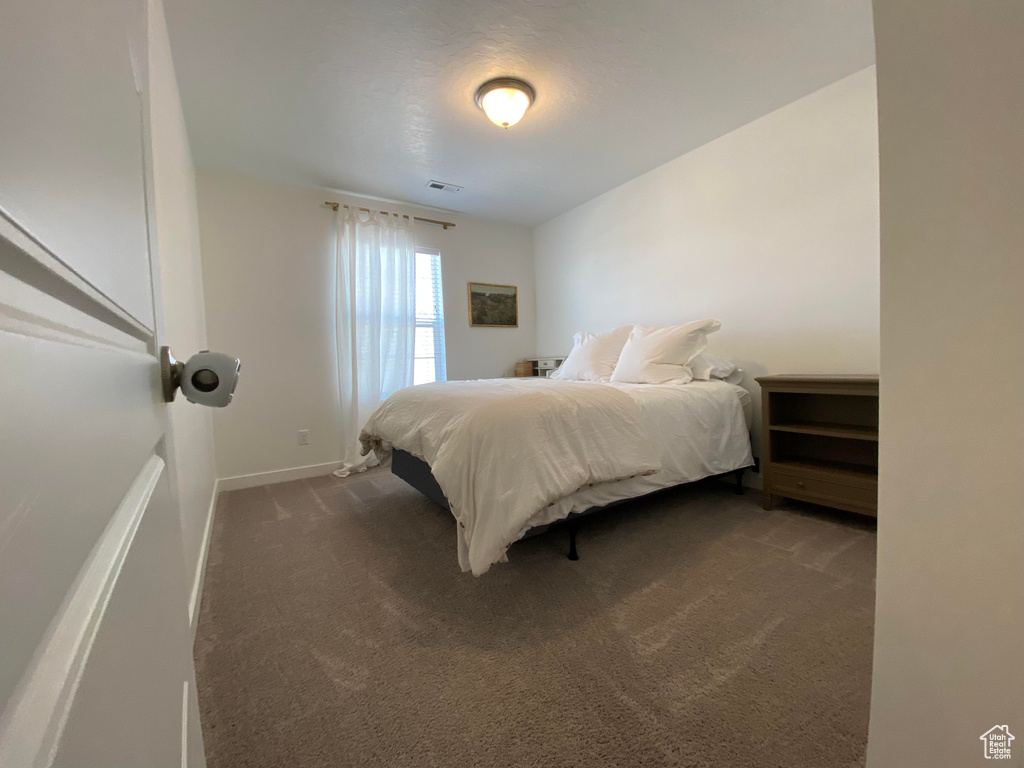 Carpeted bedroom featuring baseboards