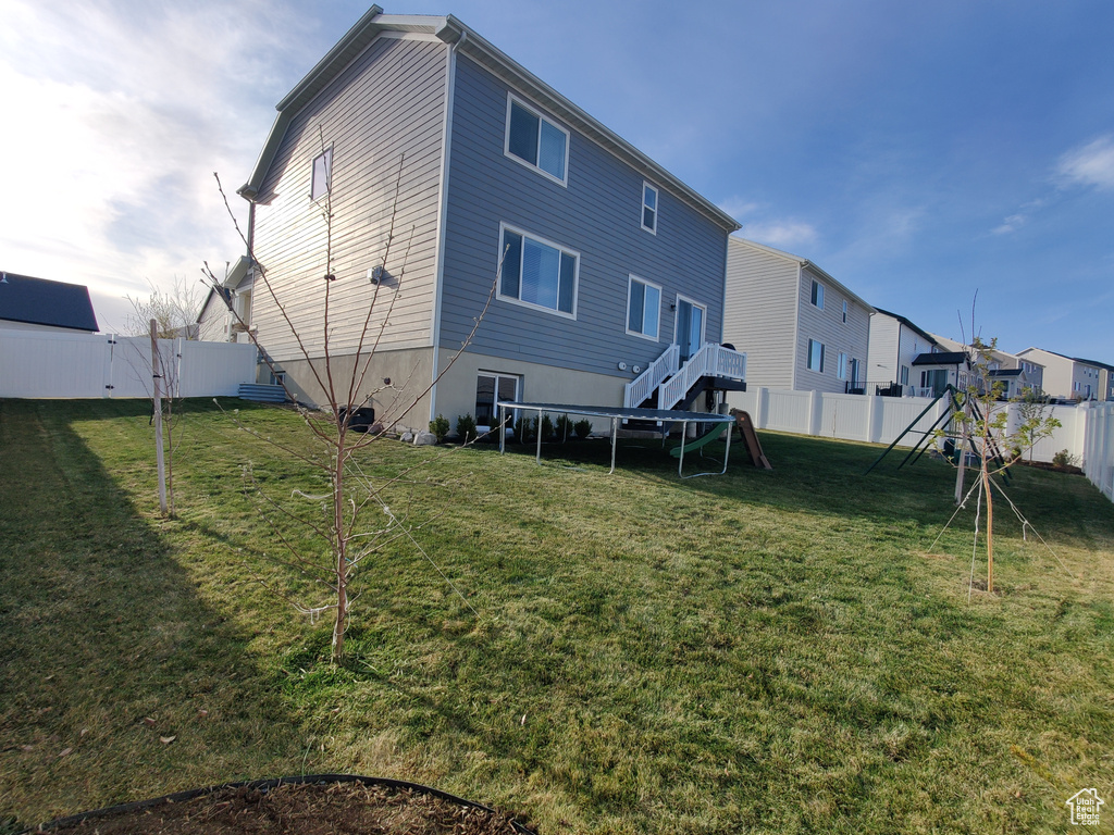Back of property with a playground and a residential view