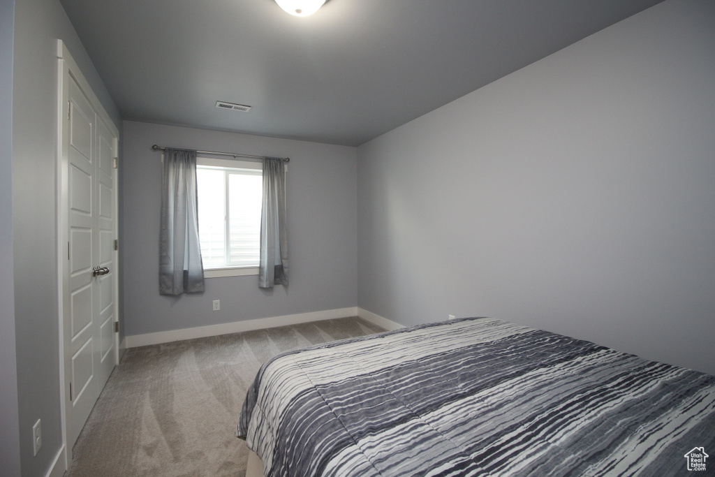 Carpeted bedroom with baseboards